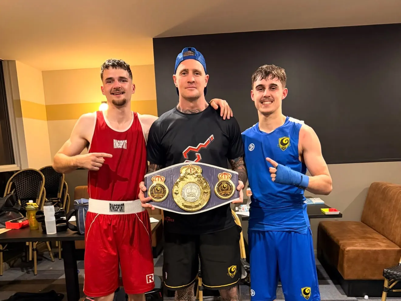 James with two fighters and a championship belt