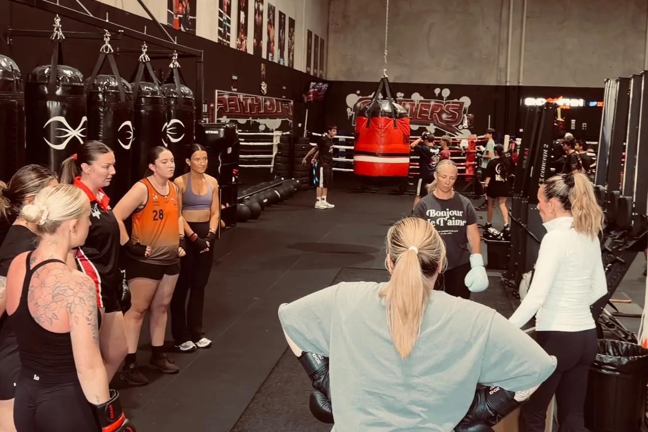 A women's class gathered in the gym