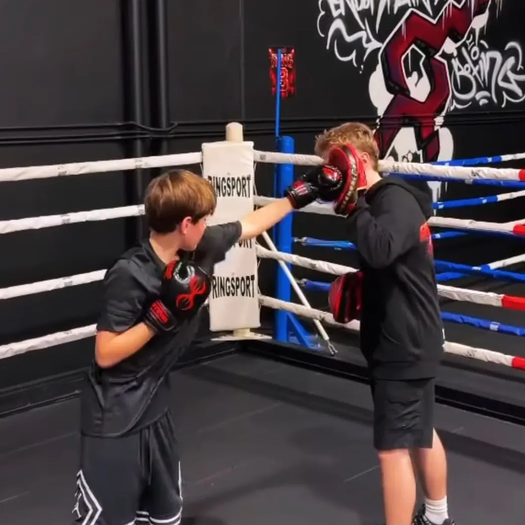 A coach holding pads for a member